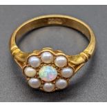 An 18ct gold ring mounted with a single opal surrounded with pearls, 4g