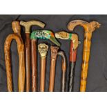 A collection of 9 walking canes, to include dogs and ducks