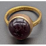 A yellow gold ring mounted with pink stone, indistinct marks, 6g