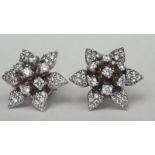 A pair of 14ct white gold diamond star earrings, 7g, D.1.75cm
