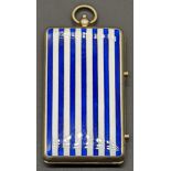 A silver and enamel compact, navy and white stripes to both side, gilt compartmentalised interior