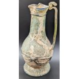 A rare large Roman or early Islamic glass jug with applied decoration, H.23cm