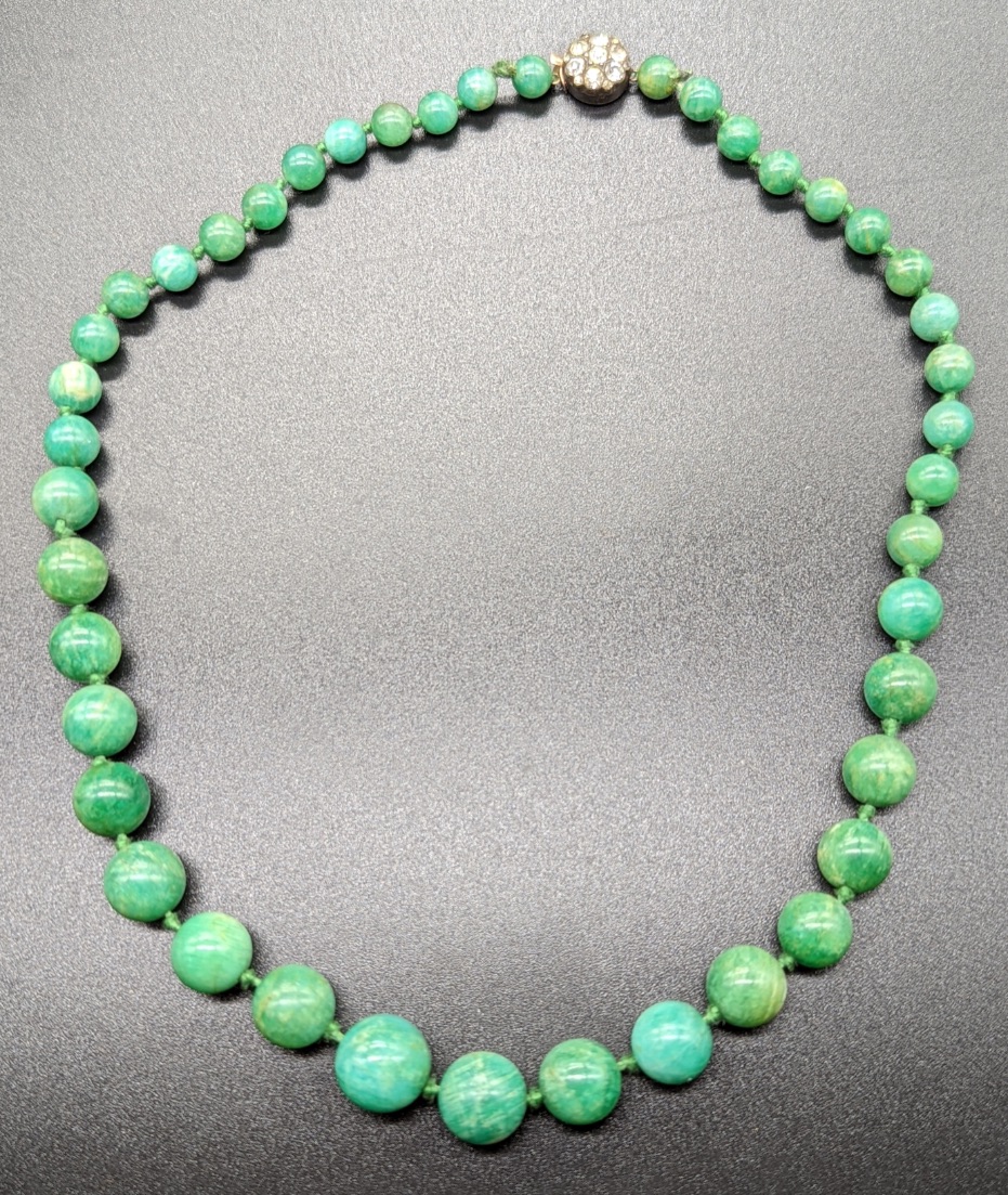 A Chinese green jade bead necklace