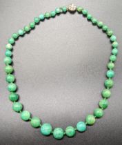 A Chinese green jade bead necklace