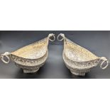 A pair of Persian silver boat-shape dishes, the handles in the form of serpents, 510g, L.21cm