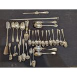 A collection of silver flatware to include a meat skewer, sugar scoop, lobster fork and multiple