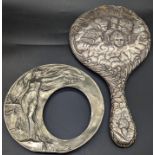 A silver cherub hand mirror (lacking glass), together with an Art Nouveau pewter picture frame