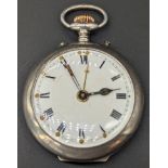 A silver open face alarm pocket watch, white enamel dial, Roman index, outer minute track and gilt