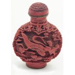A Chinese red lacquered snuff bottle, carved designs depicting a flying maiden, signed to base,