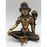 A Nepalese seated Deity Indra figure in gilded bronze and applied silver, Nepal, circa 1900, H.16cm
