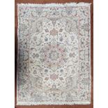 A Persian part silk rug, central medallion on a cream ground, 206cm x 155cm