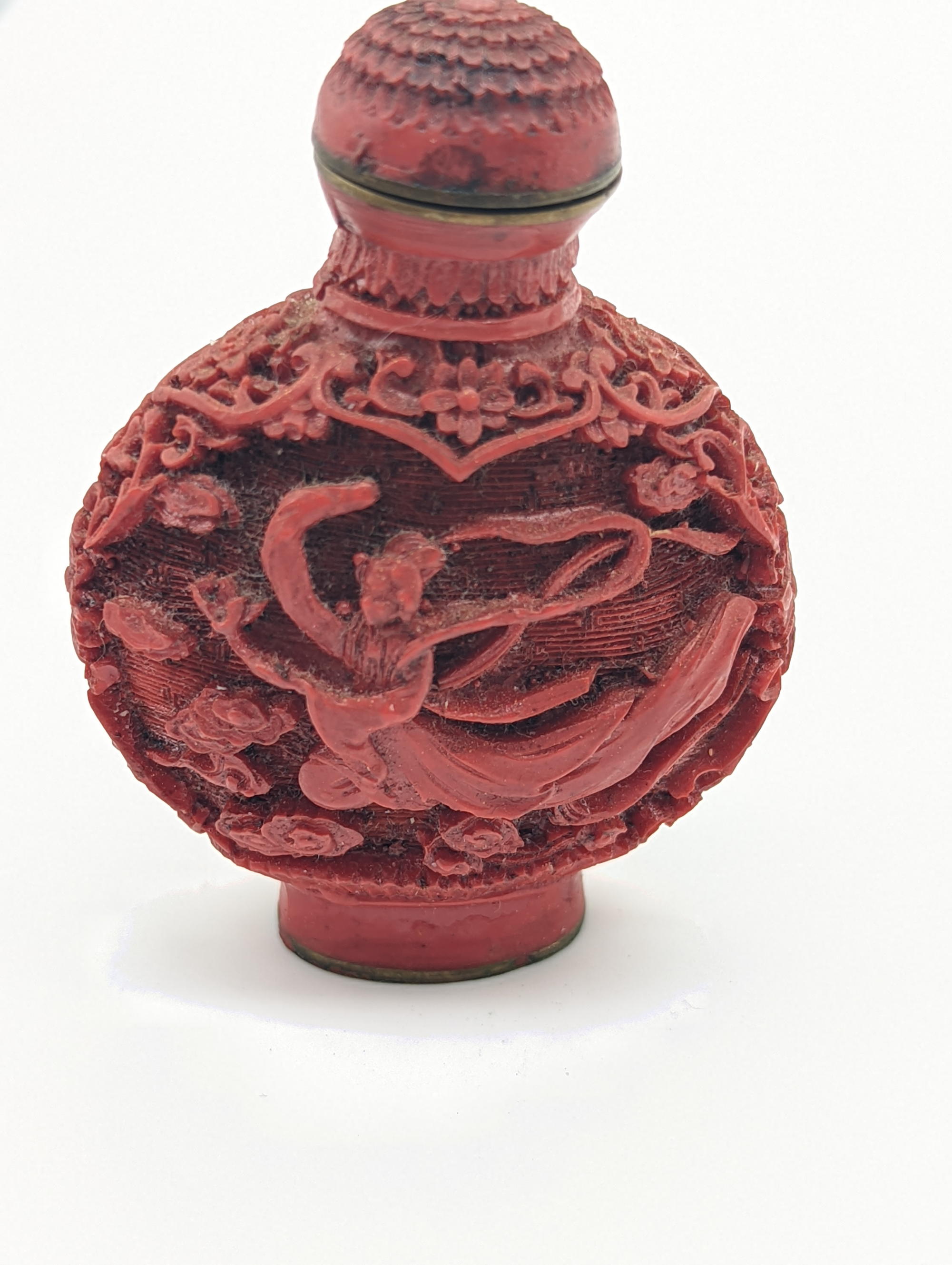 A Chinese red lacquered snuff bottle, carved designs depicting a flying maiden, signed to base, - Image 2 of 3