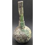 A 10th century Islamic green glass baluster vase, H.20cm