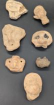 A collection of ancient pre-Colombian clay heads