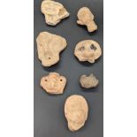 A collection of ancient pre-Colombian clay heads