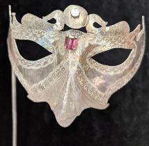 An Italian silver Venetian mask, mounted with 2 stones,