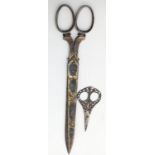 A large pair of 19th century French silver and gold inlaid scissors (L.30.5cm) with another pair