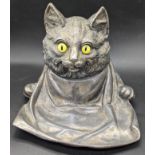 A Jennings Brothers whimsical cat with a bib inkwell, glass eyes and glass liner, circa 1900, H.