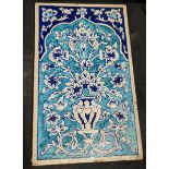 A large 19th century Indian Multan tile with floral designs, 42cm x 25.5cm