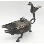 A fine 12-13th century Persian Seljuk bronze oil lamp with bird finial on handle, embossed