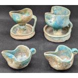 A collection of 4 12-13th Islamic Andalusian Hispano Moresque turquoise glazed pottery oil lamps