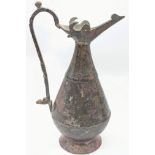 A rare 12-13th century Persian Seljuk bronze jug with bulls head top, etched decoration to body, H.