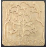 A rare 18th century Mughal Indian carved alabaster tile depicting a tree within a mihrab design with