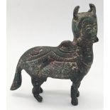 A rare possibly 16th century Indian bronze figure of the Kamadhino cow, H.10cm L.10cm