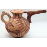 A rare ancient Persian Amlash pouring vessel with long spout, red ground depictions of animals