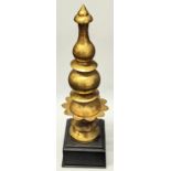 A rare 18-19th century Mughal Indian gilded copper architectural finial, mounted on wooden base, H.