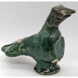 An early Islamic, possibly Umayyad, green glazed figure of a bird, H.11cm