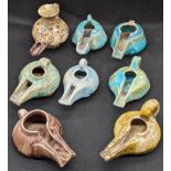 A collection of eight 12-13th century Persian kashan glazed pottery oil lamps