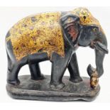 A 19th century Kashmiri black marble elephant, covered in gilt robes, red pigment remains, H.10cm