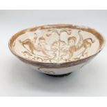 An 11th century large Seljuk Turko-Persian lustreware ceramic bowl depicting 2 figures, H.8.5cm D.23