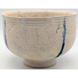 A 12-13th century Persian kashan white glazed pottery bowl, a band of embossed decor and four