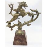 A fine 17-18th century South Indian brass Yali dragon on a wooden base, H.24cm (including base)