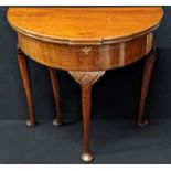 A George II mahogany demi lune tea table, double fold top, a band of marquetry inlay to frieze,