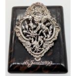 A large Victorian silver and tortoiseshell paper holder, the clip depicting a cherub, monogrammed