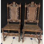 A pair of 19th century oak hall chairs with Royal Crest, barley twist supports and legs, carved