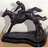 A bronze study of a racehorse with jockey jumping, raised on marble base, H.32cm L.37cm