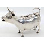 A late 19th century cow creamer, fly handle chased with foliage to hinged cover, German import marks