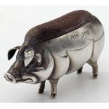 A silver pig pin cushion, hallmarked Chester, 1908, maker Adie & Lovekin Ltd, H.4.5cm L.8cm