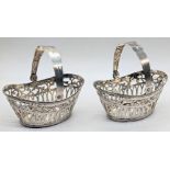 A pair of Berthold Mueller silver baskets, pierced scrolling designs, swing handles, German Hanau