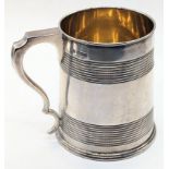 An early 20th century silver tankard, to bands of turning, gilt interior, monogrammed, hallmarked