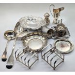 A collection of silver flatware to include a pair of Mappin & Webb toast racks, a Georgian basting