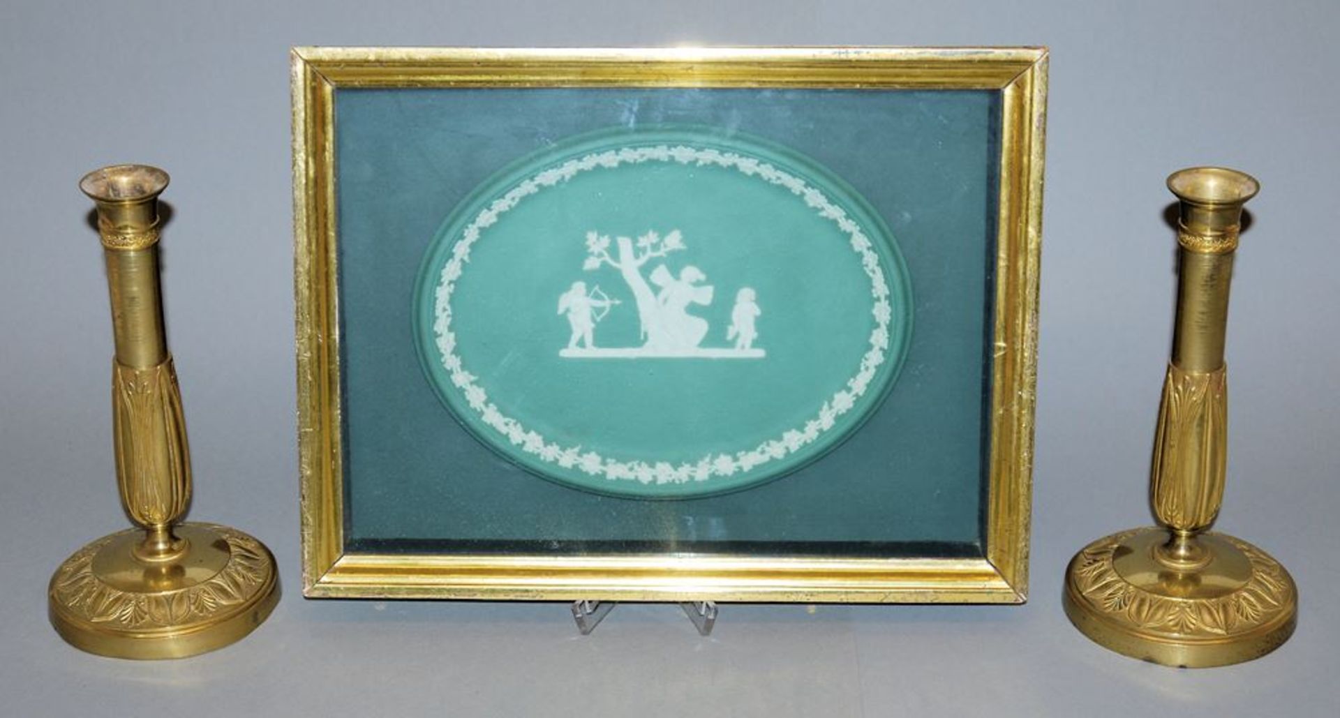 Framed Wedgwood plate and two 19th century candlesticks