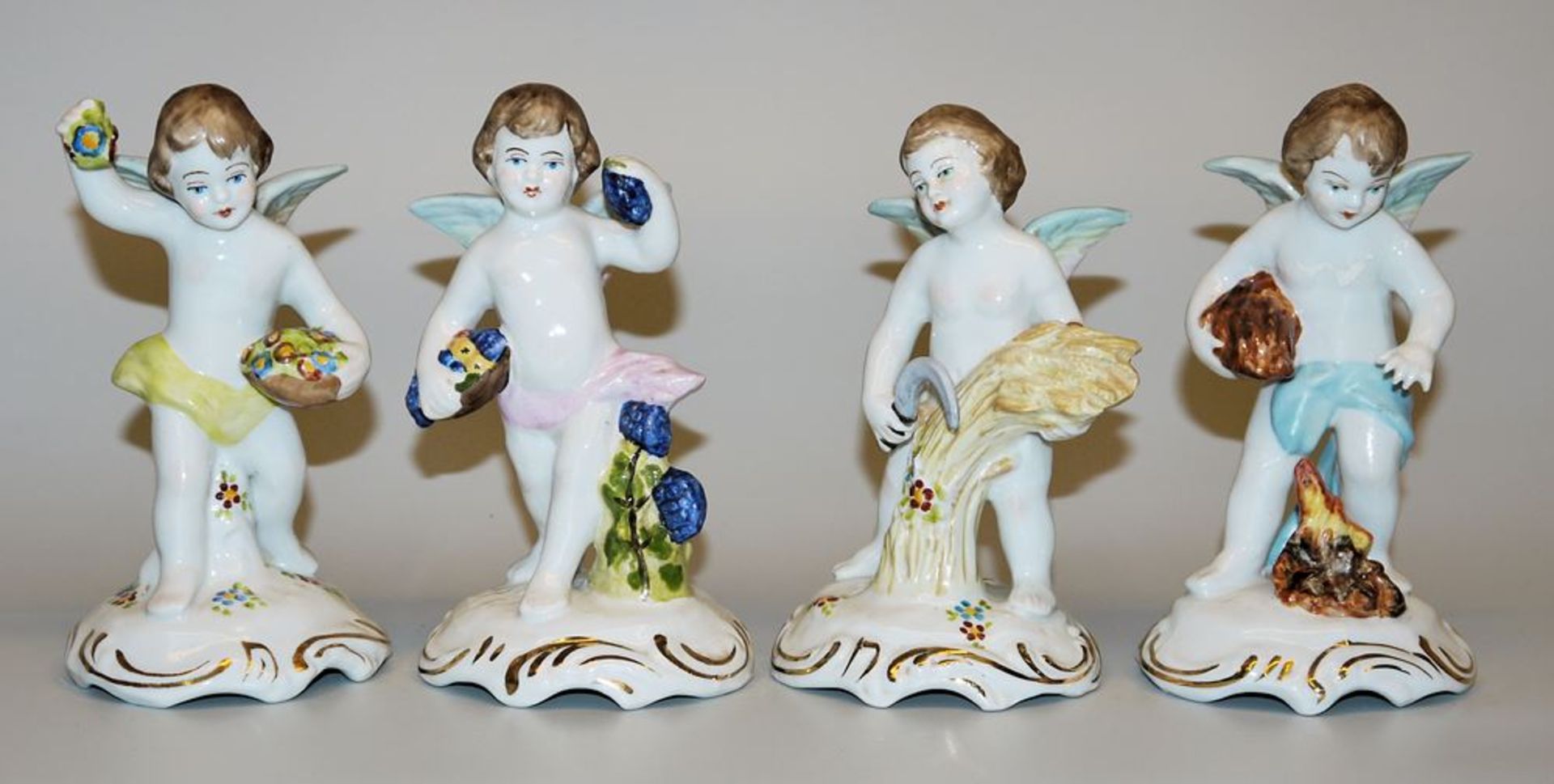 Four porcelain sculptures of seasonal putti circa 1900