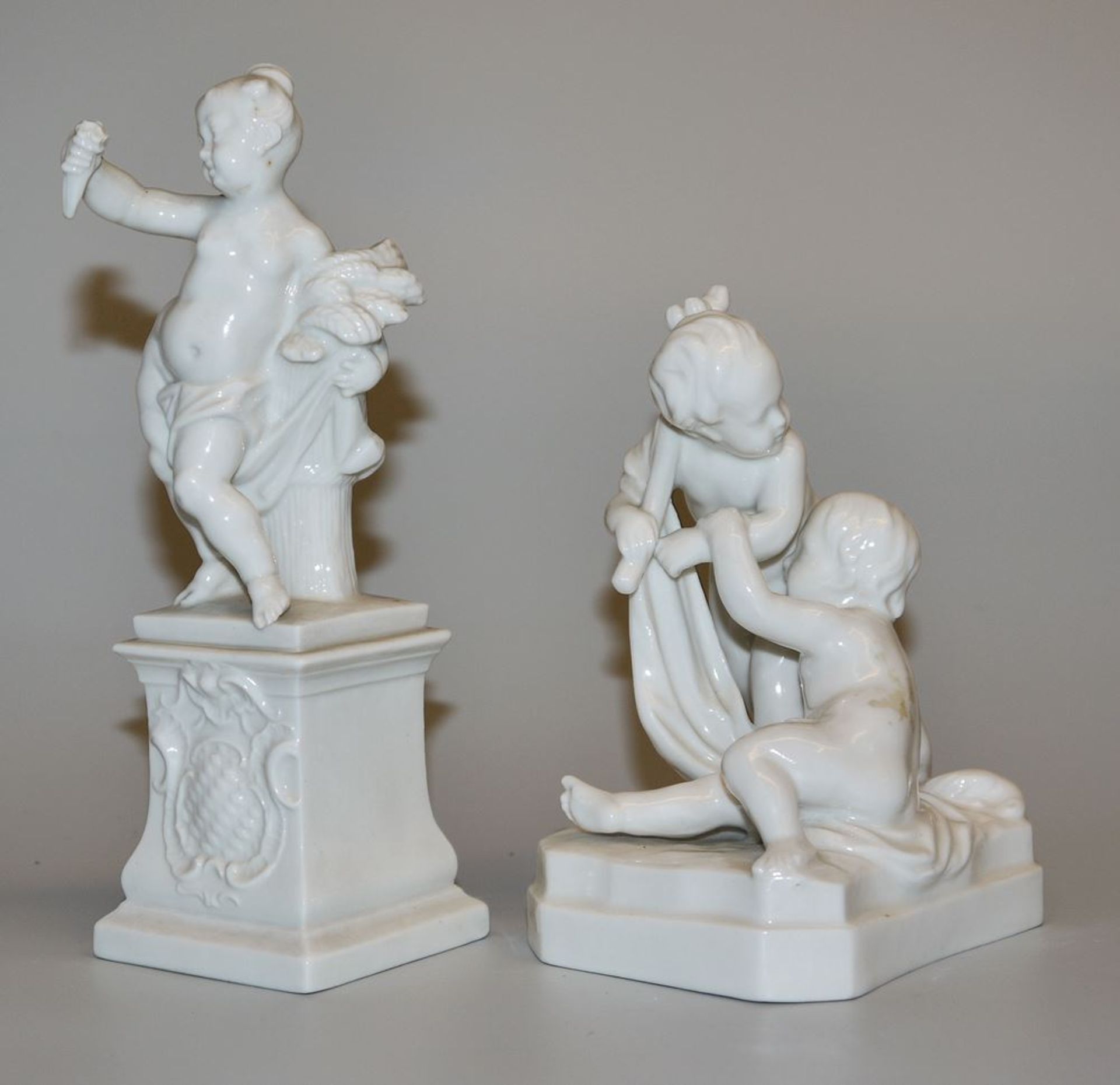 Two porcelain sculptures: Seasons Putto Summer, Bustelli für Nymphenburg & Putten bei der Jagd, pro