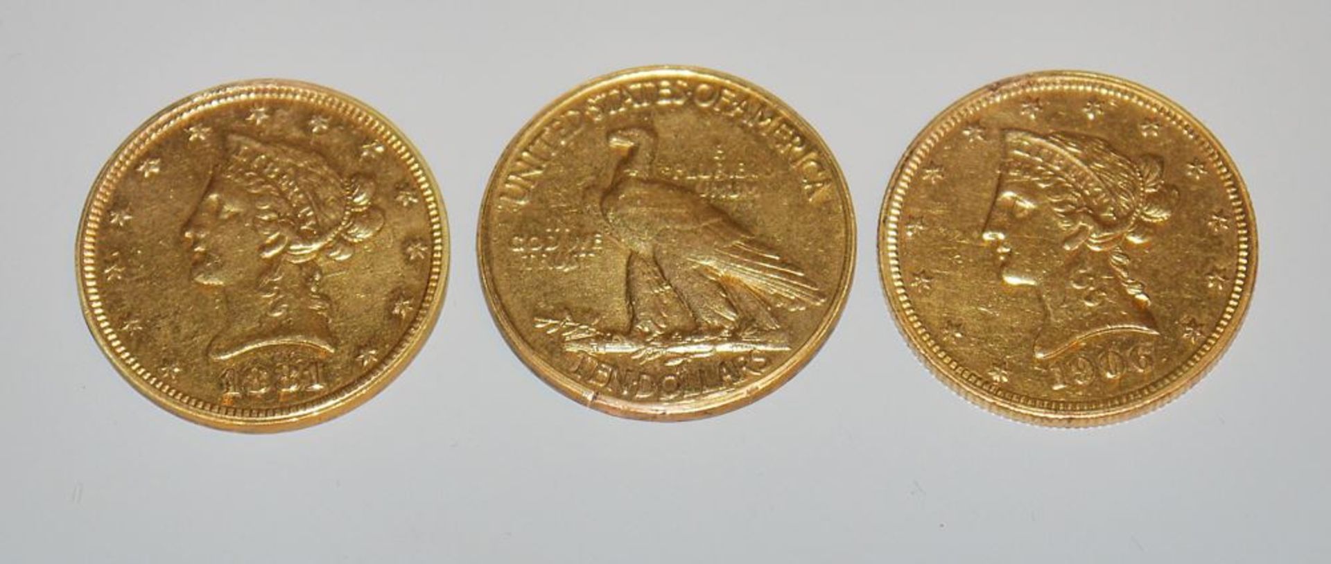 Drei Goldmünzen 10 Dollars USA, 1881/ 1906/ 1932