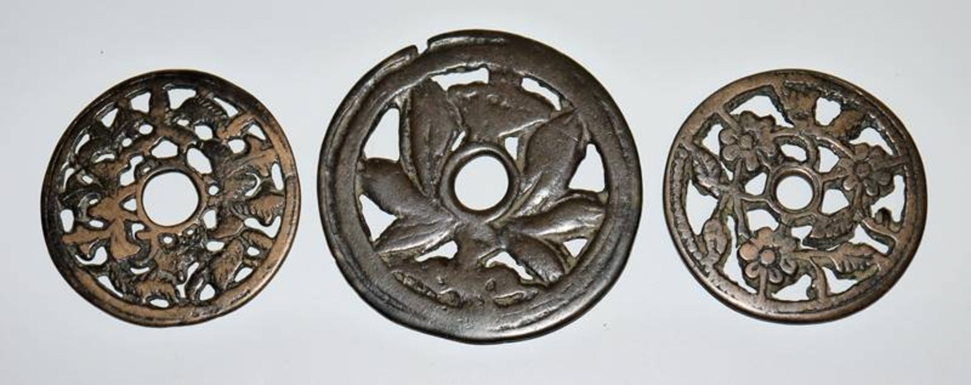 Three numismatic charms with flowers from the Chinese Ming/Qing period